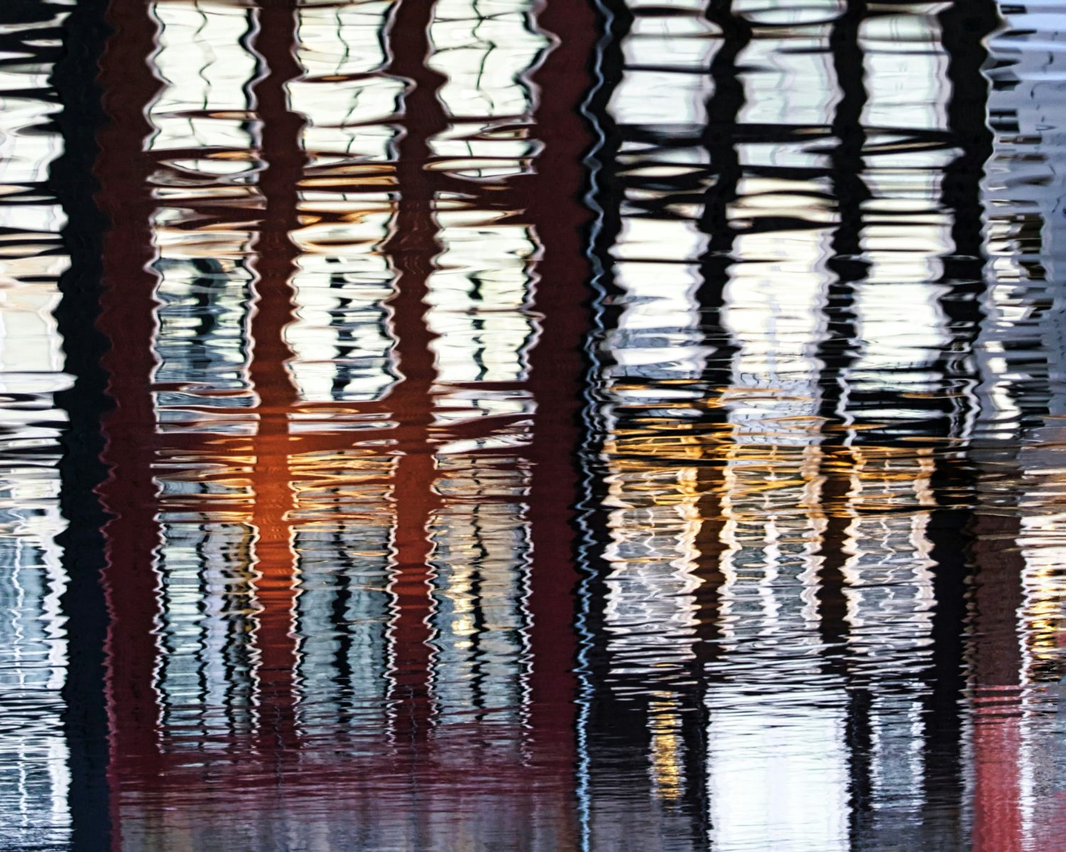 Reflection of buildings distorted in water.
